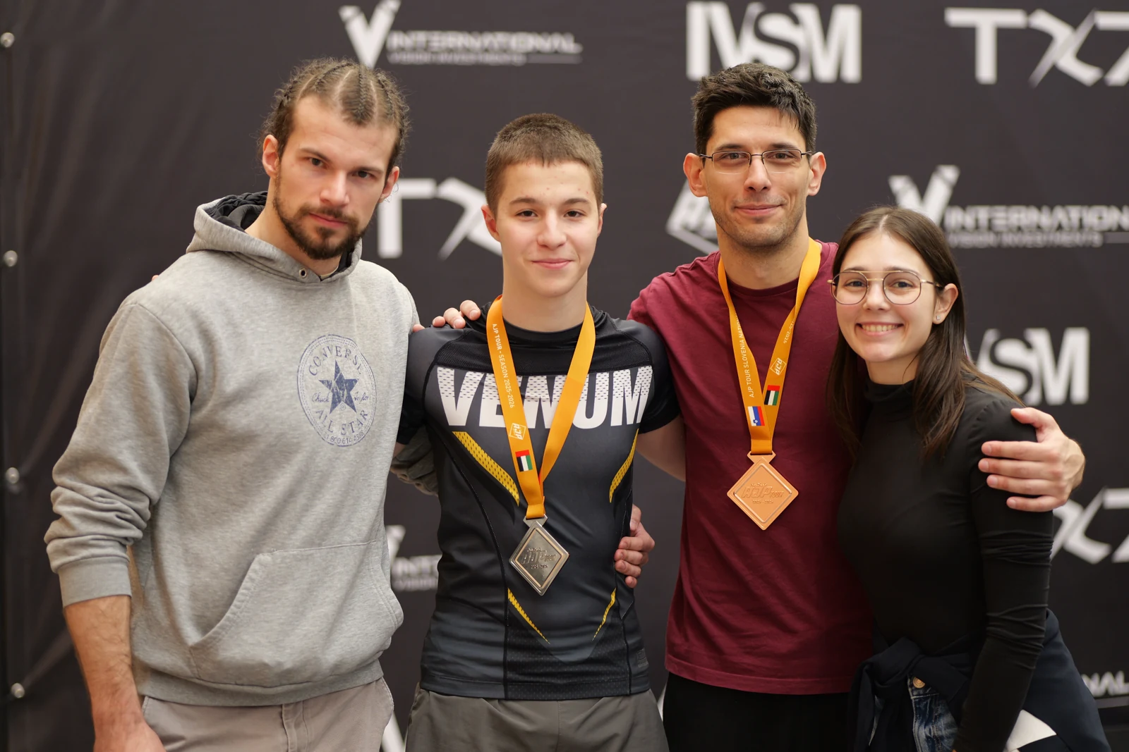 Four team members together with medals